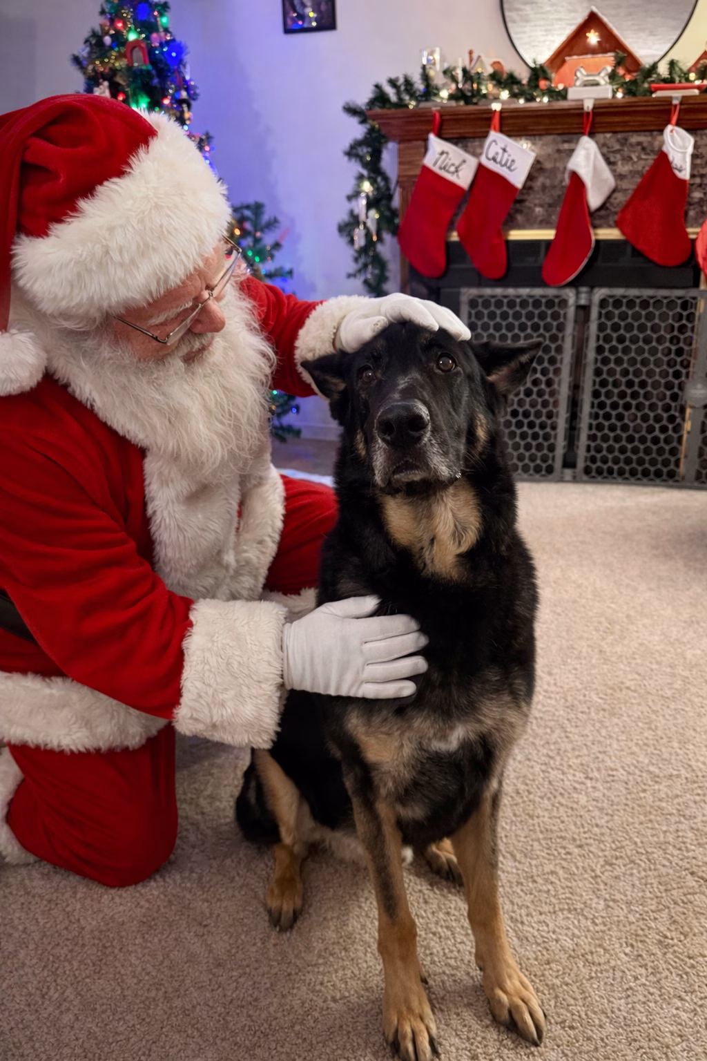 Randy posing with Santa by the Christmas tree